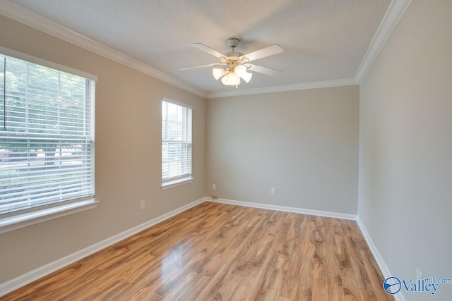 unfurnished room with ornamental molding, light wood finished floors, a ceiling fan, baseboards, and a textured ceiling