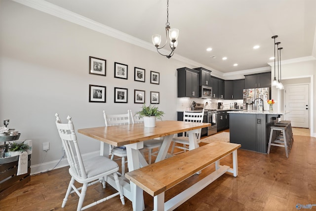 dining space with ornamental molding, a notable chandelier, hardwood / wood-style floors, and recessed lighting