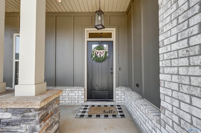 doorway to property featuring board and batten siding