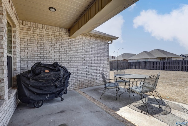 view of patio with fence and outdoor dining space