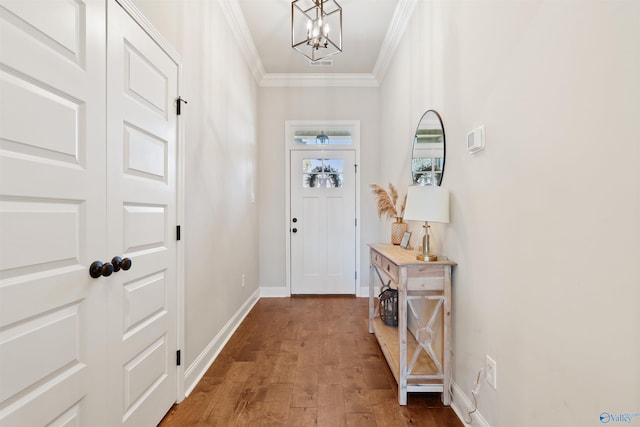 doorway to outside with crown molding, a chandelier, baseboards, and dark wood-type flooring