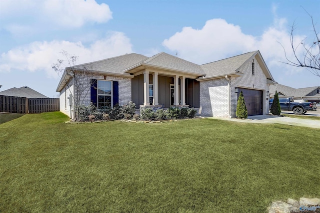 view of front of property featuring a front yard, brick siding, an attached garage, and fence