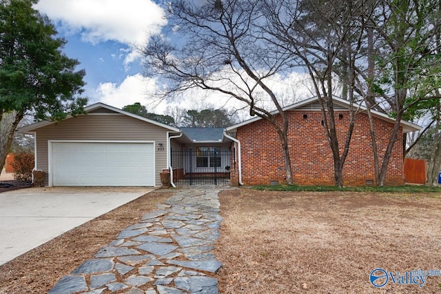 ranch-style home featuring crawl space, driveway, an attached garage, and brick siding