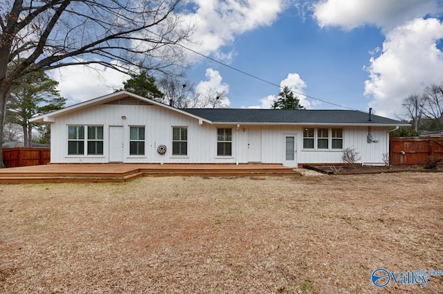 view of front of house featuring a deck and fence