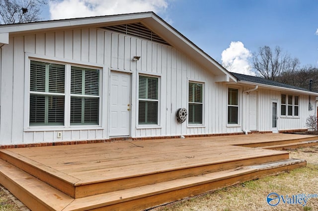 rear view of property featuring a deck