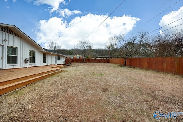 view of yard featuring fence and a deck