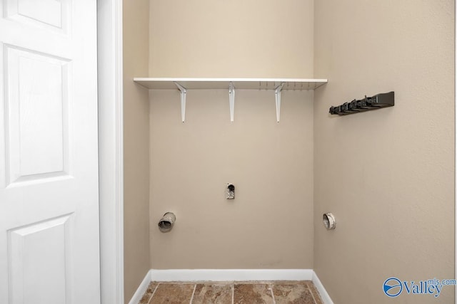 clothes washing area with laundry area and baseboards