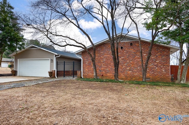 view of front of home featuring driveway, an attached garage, fence, and brick siding