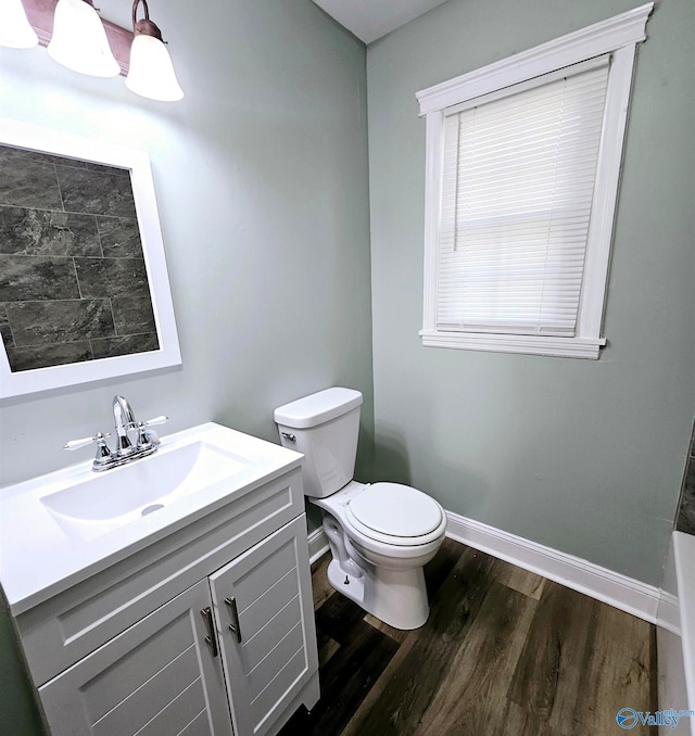 bathroom with vanity, hardwood / wood-style floors, and toilet