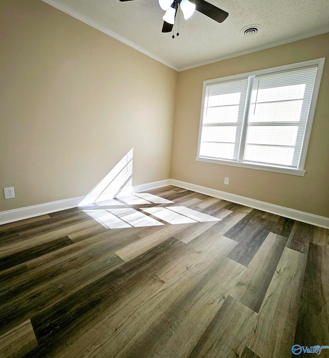 empty room with ornamental molding, ceiling fan, a textured ceiling, and dark hardwood / wood-style flooring