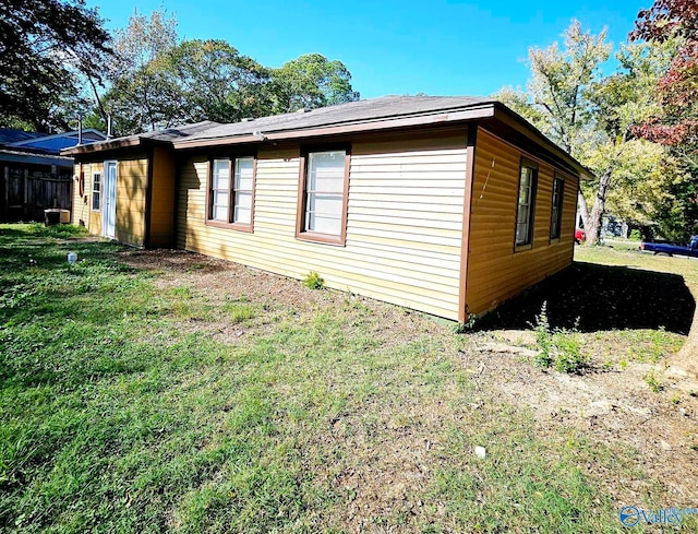 view of side of home featuring a yard