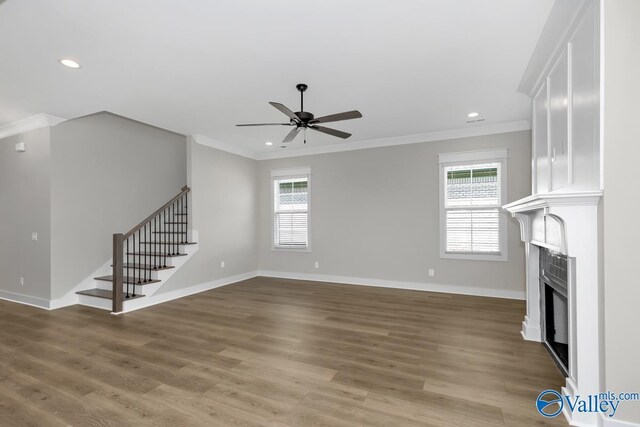 111 Mayapple Trl, Madison, AL 35756 - unfurnished living room featuring a fireplace, stairs, a ceiling fan, wood finished floors, and ornamental molding