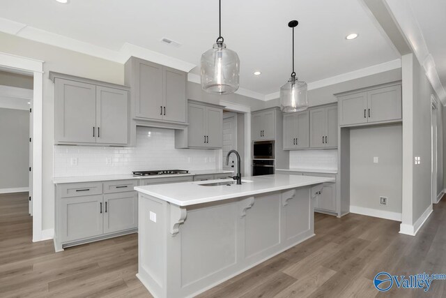111 Mayapple Trl, Madison, AL 35756 - kitchen with backsplash, visible vents, appliances with stainless steel finishes, a sink, and gray cabinetry