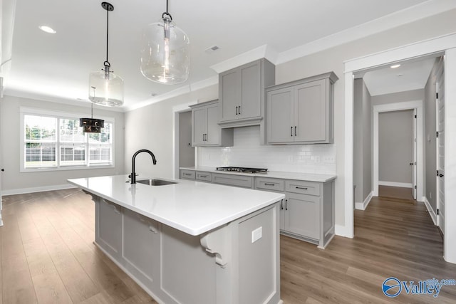 111 Mayapple Trl, Madison, AL 35756 - kitchen with a sink, baseboards, gray cabinets, and a center island with sink