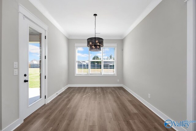 111 Mayapple Trl, Madison, AL 35756 - unfurnished dining area with baseboards, ornamental molding, dark wood-style flooring, and a chandelier