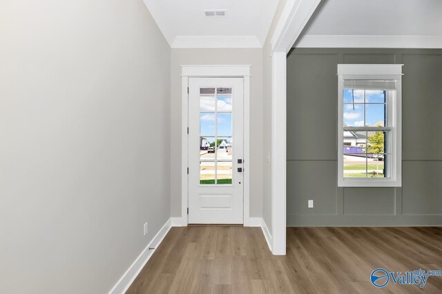 111 Mayapple Trl, Madison, AL 35756 - doorway to outside featuring visible vents, ornamental molding, baseboards, and wood finished floors