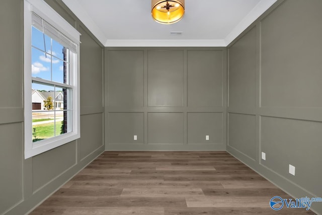 111 Mayapple Trl, Madison, AL 35756 - spare room with visible vents, light wood-type flooring, and a decorative wall