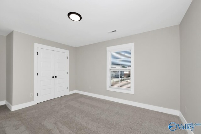111 Mayapple Trl, Madison, AL 35756 - unfurnished bedroom featuring carpet floors, baseboards, and visible vents