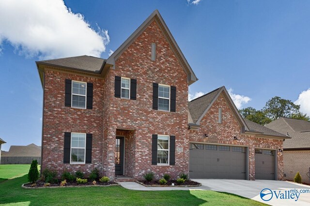 111 Mayapple Trl, Madison, AL 35756 - traditional home featuring a garage, a front yard, brick siding, a shingled roof, and concrete driveway