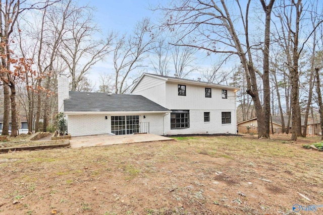 back of house featuring a patio area and a lawn