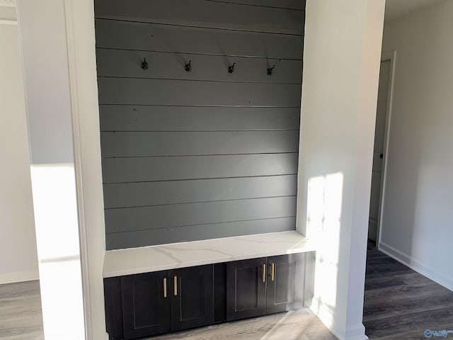 mudroom featuring wood walls and light hardwood / wood-style flooring