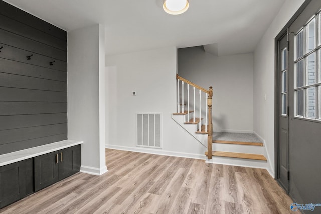 mudroom featuring wooden walls and light wood-type flooring