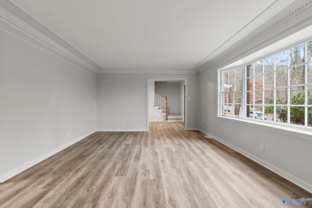 unfurnished living room with light wood-type flooring and ornamental molding