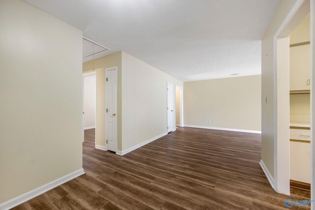 104 Sycamore Pl, Athens, AL 35611 - empty room with attic access, dark wood-type flooring, and baseboards