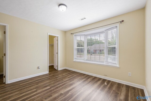 104 Sycamore Pl, Athens, AL 35611 - unfurnished bedroom with dark wood-style floors, baseboards, a spacious closet, and a closet