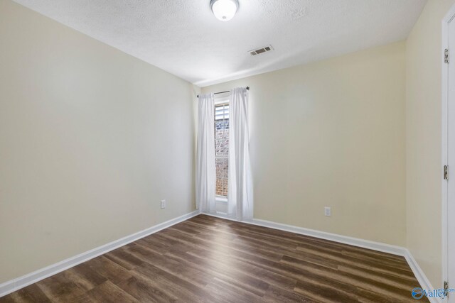 104 Sycamore Pl, Athens, AL 35611 - unfurnished room featuring dark wood finished floors, baseboards, and a textured ceiling