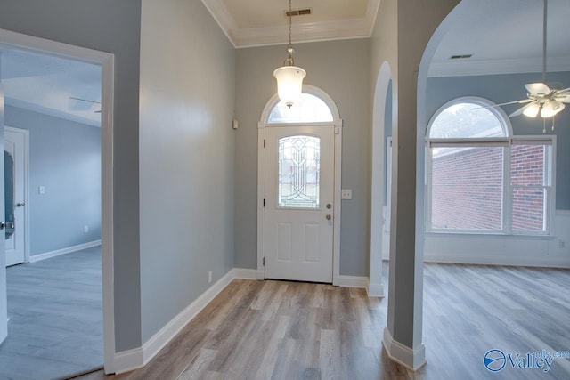 entryway featuring ceiling fan, visible vents, arched walkways, and wood finished floors