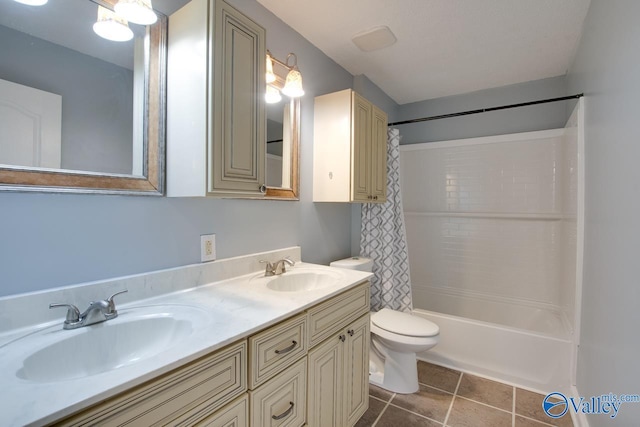 bathroom featuring a sink, toilet, shower / tub combo with curtain, and tile patterned flooring