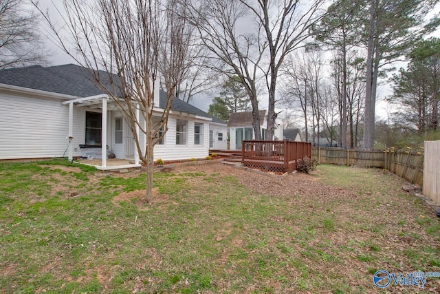 view of yard with a deck and a fenced backyard