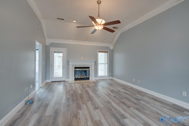 unfurnished living room featuring vaulted ceiling, a ceiling fan, visible vents, and ornamental molding