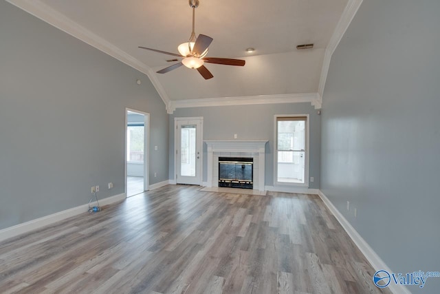 unfurnished living room with baseboards, ornamental molding, a ceiling fan, and vaulted ceiling