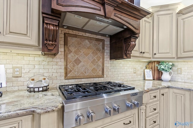 kitchen with cream cabinetry, stainless steel gas stovetop, and premium range hood