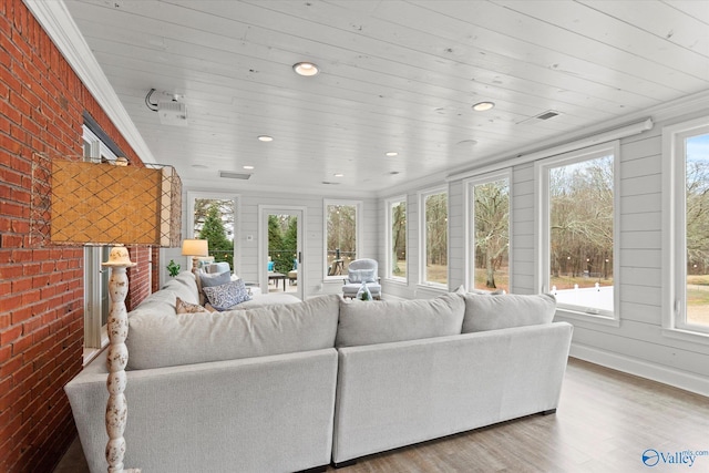 sunroom featuring a healthy amount of sunlight and wooden ceiling