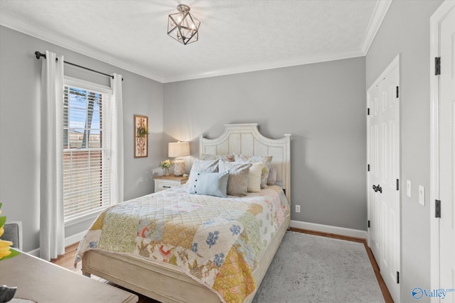 bedroom with ornamental molding and light hardwood / wood-style flooring