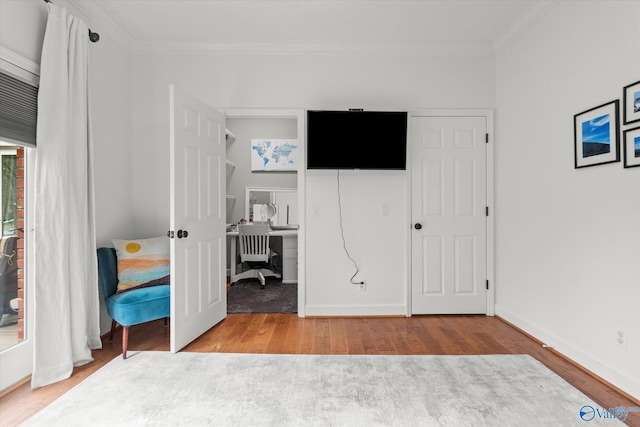 unfurnished bedroom featuring crown molding and light hardwood / wood-style flooring