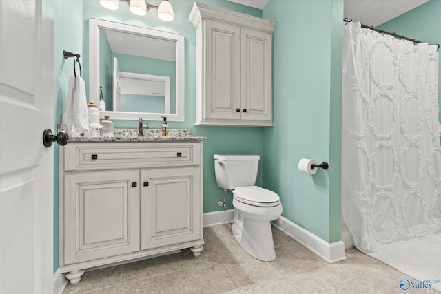 bathroom featuring walk in shower, vanity, toilet, and tile patterned flooring