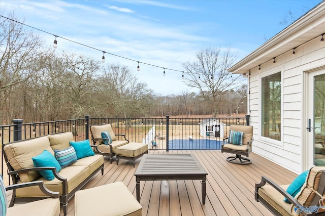 wooden terrace with an outdoor living space and a swimming pool