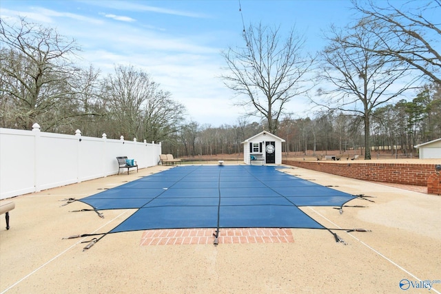 view of swimming pool with a patio and an outdoor structure