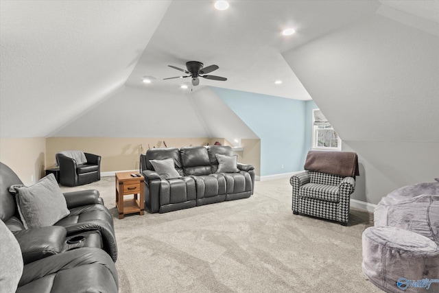 carpeted living room featuring ceiling fan, vaulted ceiling, and a textured ceiling