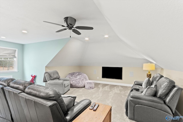 living room with lofted ceiling, ceiling fan, and carpet flooring