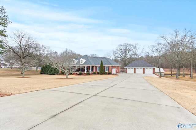 view of front of home with a garage, a front yard, and covered porch