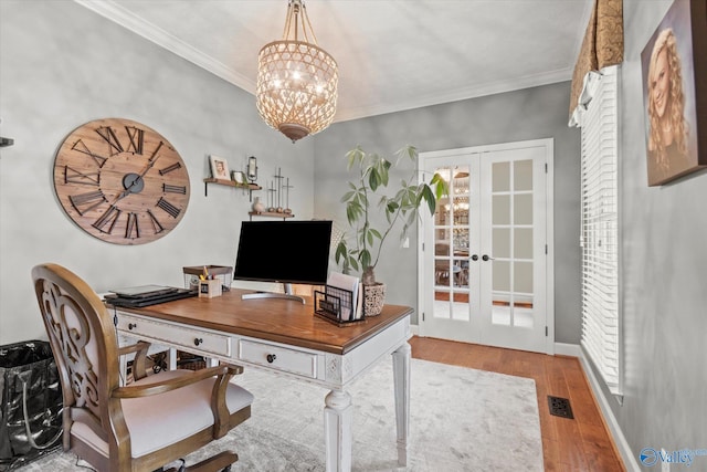 office area featuring ornamental molding, hardwood / wood-style floors, an inviting chandelier, and french doors