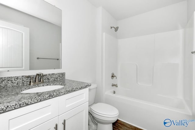 full bathroom with toilet, shower / bathtub combination, wood finished floors, and vanity