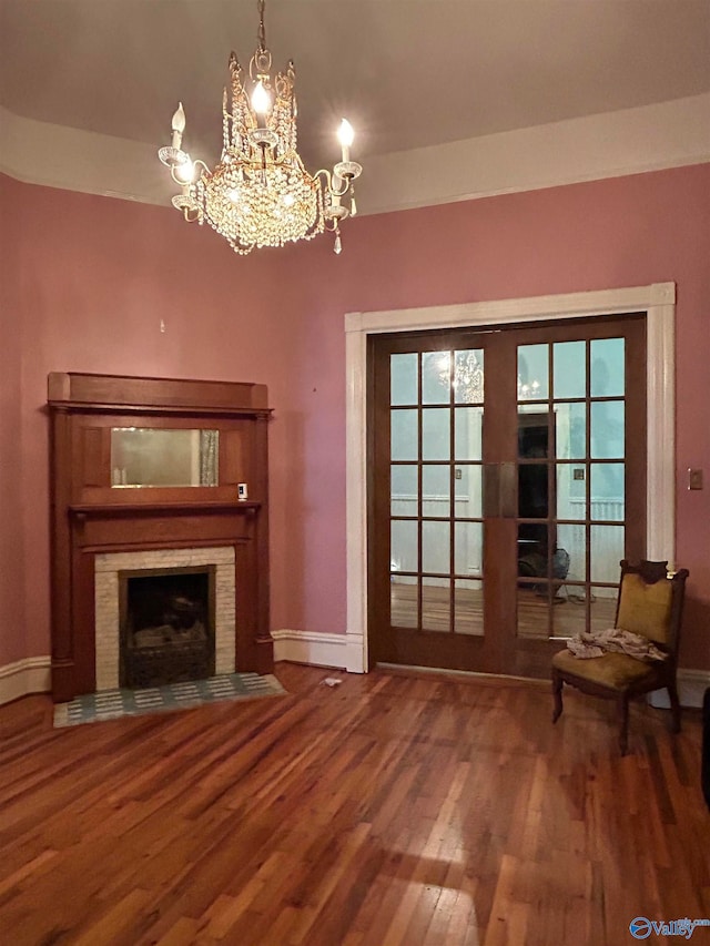 unfurnished living room featuring hardwood / wood-style flooring and a notable chandelier