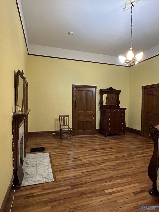 bedroom with a chandelier and hardwood / wood-style flooring