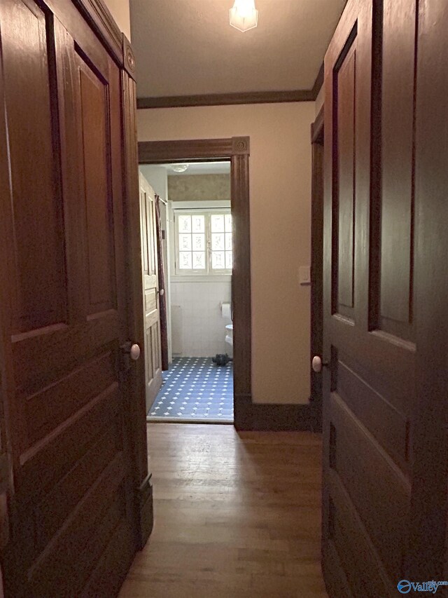 hallway featuring crown molding and hardwood / wood-style floors